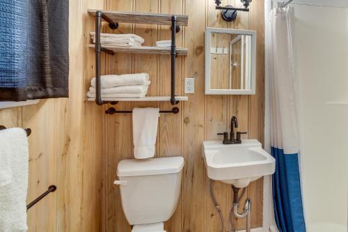 a bathroom with a toilet and a sink at Lakeside Reeds Spring Home w/ Deck & Pool Access! in Reeds Spring