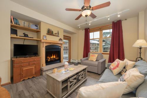 a living room with a couch and a fireplace at Zephyr Mountain Lodge Unit 1306 in Winter Park