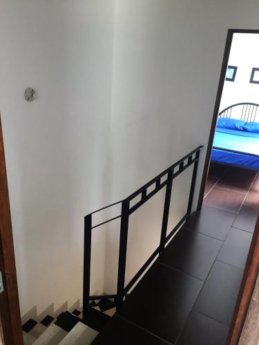 a staircase in a room with a mirror at Conjunto Buganviles - in Girardot