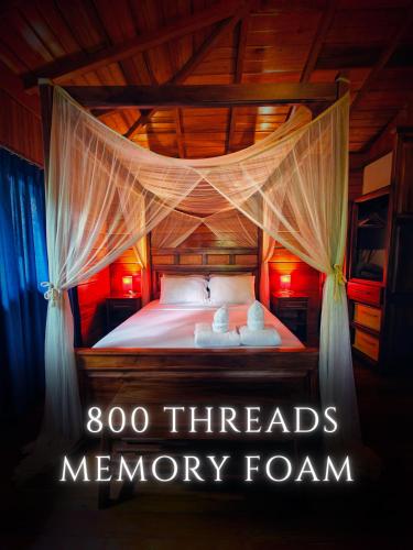 a bedroom with a bed with two towels on it at The River House in Puerto Quito