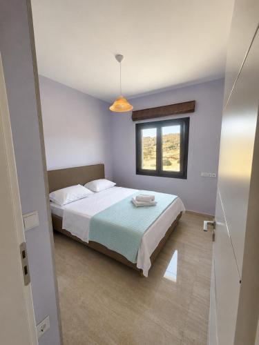 a bedroom with a bed and a window at Villa relax glinado luluvo in Glinado Naxos