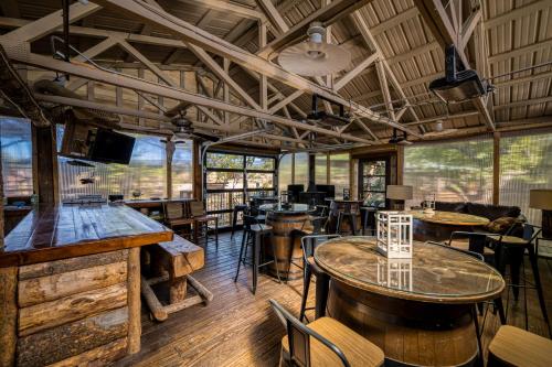 a restaurant with tables and chairs and windows at Basecamp 2 at the Cedaredge Lodge in Cedaredge