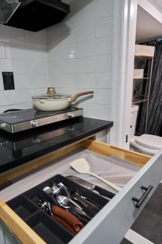 a drawer in a kitchen with a bowl on a counter at Joynest Nest - Private Entry & Bath in Newark