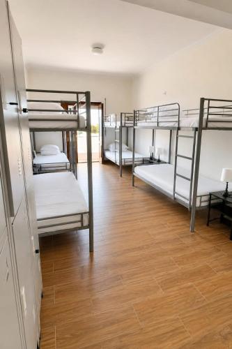 a room with a bunch of bunk beds at Albani Hostel in Palmela