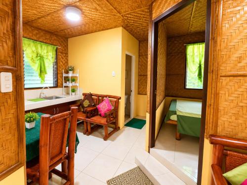 a small room with a sink and a bedroom at Argana Cottages in Dauin