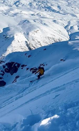a person is skiing down a snow covered mountain at Para 6 pax La Parva in Lo Barnechea