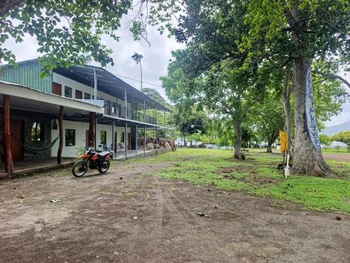 a motorcycle parked in front of a building at Kencho's Beach House-Sunset & Beachside stay in Ometepe in El Perú