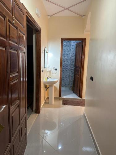 a bathroom with a sink and a toilet and a mirror at Jannat Résidence in Ouarzazate