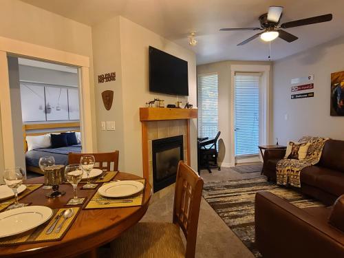 a living room with a table and a fireplace at Fraser Crossing 3417 in Winter Park