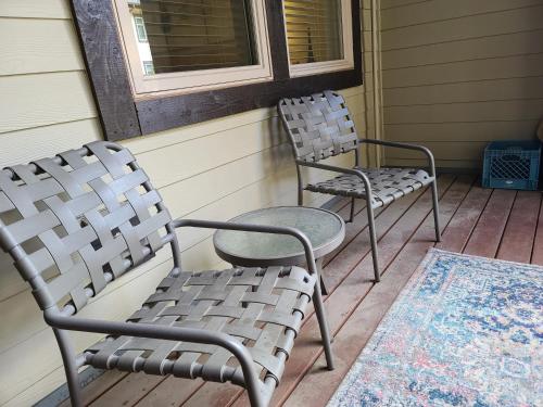 two chairs sitting on a porch next to a window at Fraser Crossing 3417 in Winter Park