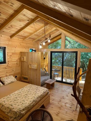 a bedroom with a bed in a log cabin at BetosGarden in Ulcinj