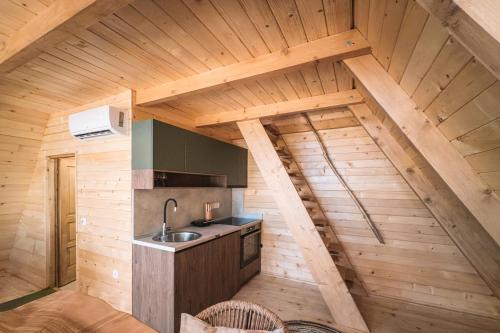 an attic kitchen with a sink and a stove at BetosGarden in Ulcinj