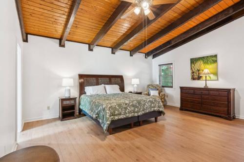 a bedroom with a bed and a wooden ceiling at Sues Lake House in Buford
