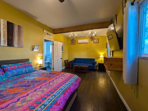 a bedroom with a bed and a couch in it at Denver Oasis 5BR Home with Hot Tub, Sleeps 16 in Denver