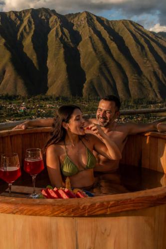 a man and a woman sitting in a bath tub at Tara Vegan Lodge - Sacred Valley in Urubamba