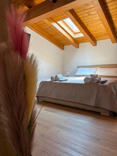 a bedroom with a large bed with a wooden ceiling at Amarè House in Catania