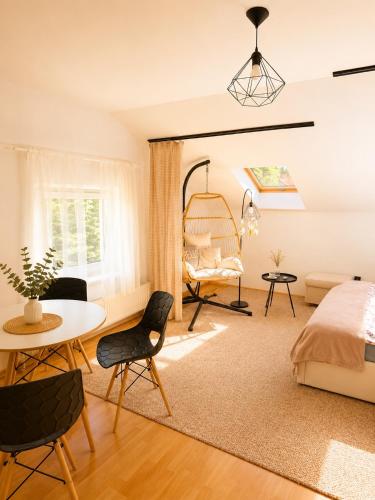 a bedroom with a bed and a table and chairs at GóralSki in Wisła