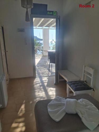 a bedroom with a bed and a room with a table at Sunset Hotel Kini Beachside in Kini