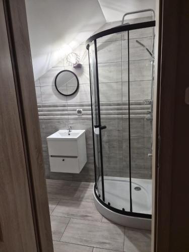 a bathroom with a shower and a sink at Windrose in Ustronie Morskie