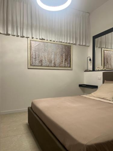 a bedroom with a bed and a large window at Chloè Vacanze in Iesi