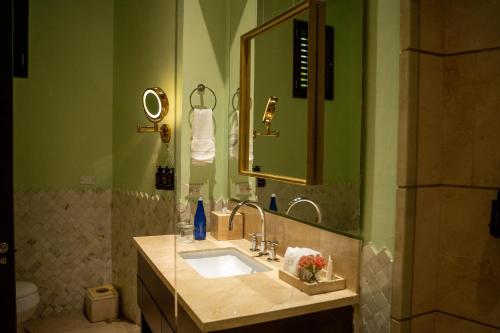 a bathroom with a sink and a mirror at Hotel Capellán de Getsemaní in Cartagena de Indias