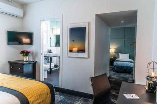 a hotel room with a bed and a mirror at Steveston Cafe & Hotel in Richmond