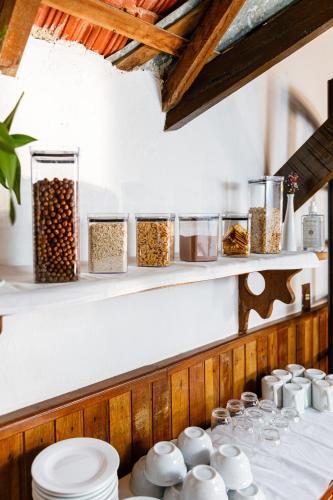 a shelf with jars of nuts and other food items at Pousada Sonho Verde in Monte Verde
