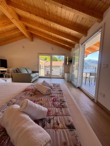 a bedroom with a large bed and a large window at Panoramic and view apartments in Lezzeno