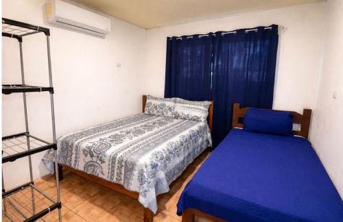 a bedroom with a bed and a bed and a ladder at Brisas Griegas in Quepos