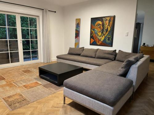 a living room with two couches and a coffee table at Wood Street Haven in Greytown