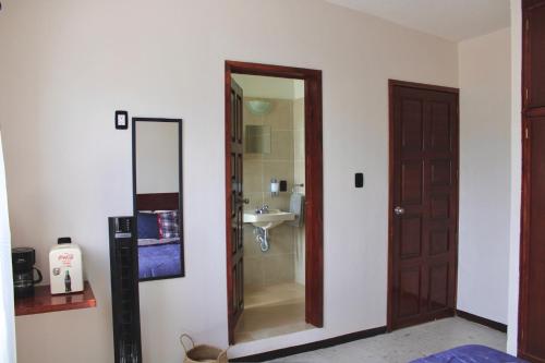 a bathroom with a mirror and a sink at Luffa Hostel in Santa Lucía