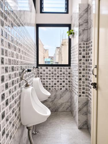 two white sinks in a bathroom with a window at Hotel Eva Palace in Chatra