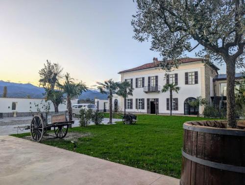 a large white house with a bench in front of it at Corte Tegassa Pool & Spa in Pinerolo