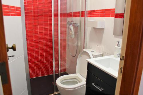 a bathroom with a shower and a toilet and a sink at Casa do Castelo - Calm & lovely 2-bedroom Apt Near the Beach in Sesimbra