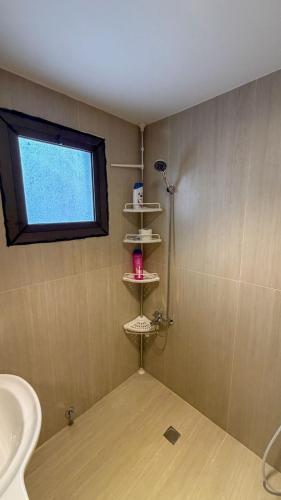 a bathroom with a shower and a sink and a window at Pearl sea in Al Jubail