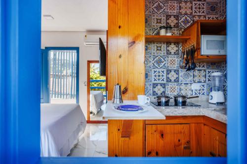 a kitchen with a sink and a counter top at Vila Maria Pousada in Jericoacoara