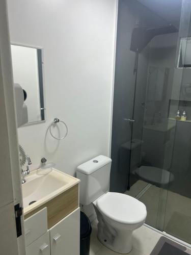 a bathroom with a toilet and a sink and a shower at Casa completa bem equipada ótima localização in Joinville