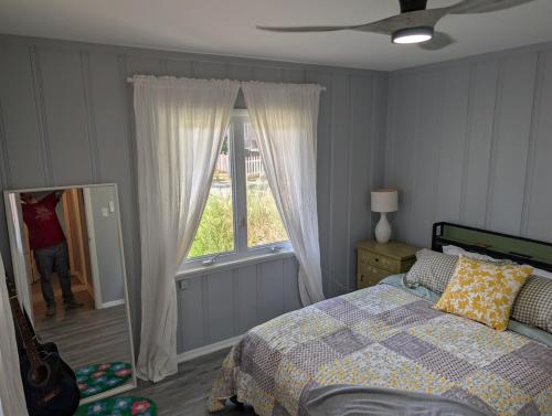 a bedroom with a bed and a window at Otterspace at the beach in Shady Side