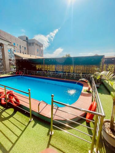 a large swimming pool with a water slide at Lexworld Hotels in Aba