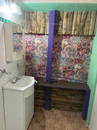a bathroom with a sink and a shower curtain at Rancho Por Fin in Barreal