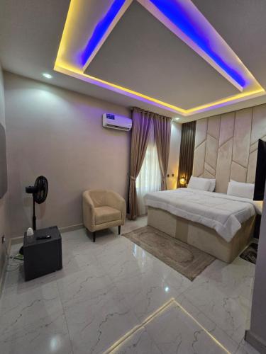 a hotel room with a bed and a blue light at O2 Continental Suites in Kubwa