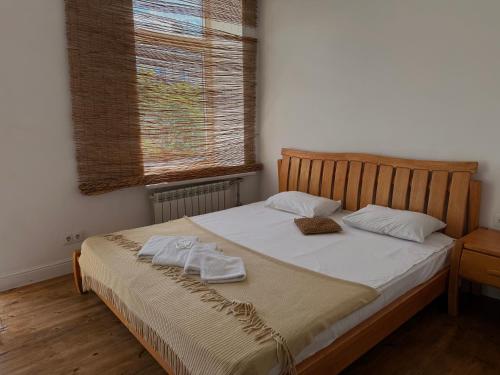 a bedroom with a bed with two towels on it at Belle Art Hotel in Odesa