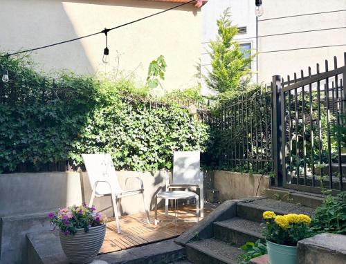 a patio with two chairs and a fence at SEA LEVEL Sopot in Sopot