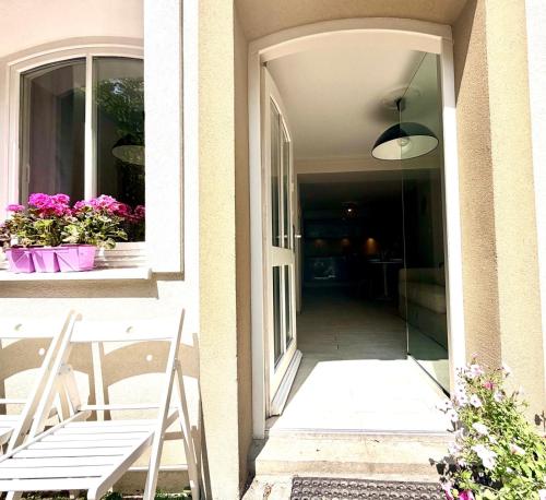 an open door to a house with flowers on a window at SEA LEVEL Sopot in Sopot