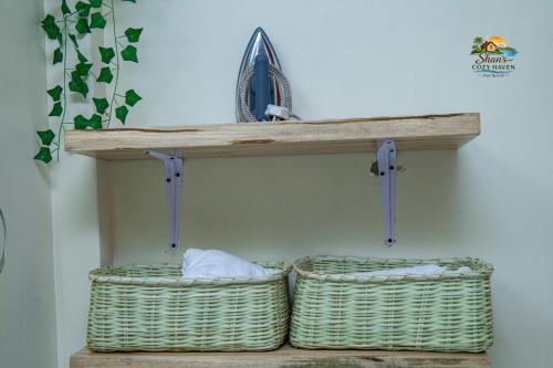 two baskets sitting on a shelf in a room at Shan in Jinja