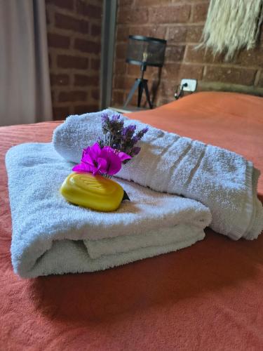 a towel with a flower on top of it on a table at Cabañas 2TIERRAS in Chicoana