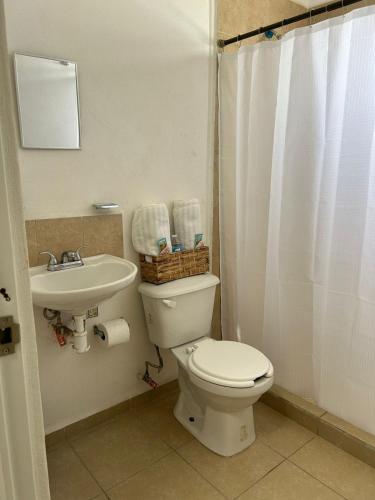 a bathroom with a toilet and a sink at Casa Morelia ideal, rest or work in San Carlos