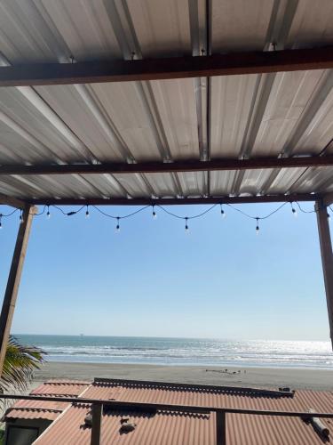 a view of the ocean from the beach at Negritos Beach House in Negritos