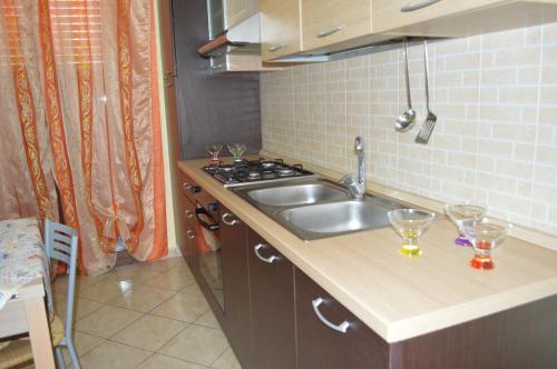 a small kitchen with a sink and a stove at Casa Isulidda in San Vito lo Capo