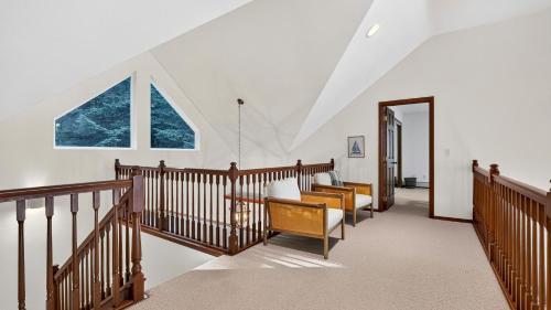 a hallway with wooden railings and a window at Eagles Bluff by AvantStay in Greenbank